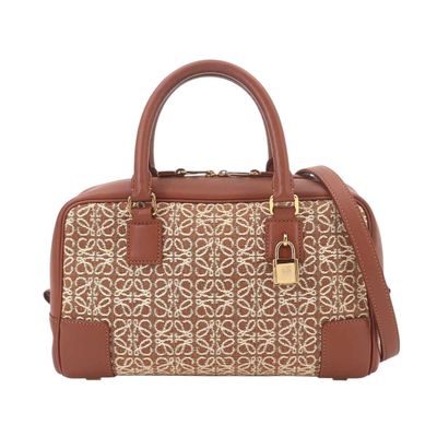 a brown and white handbag on a white background