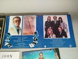three cd ' s with pictures of people on them on a table