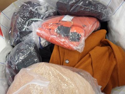 a pile of clothes and bags in a plastic bag