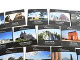 a lot of postcards that are on a table