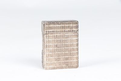 a small silver object that is sitting on a white surface
