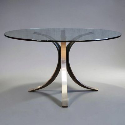 an image of a glass table with a metal base and a glass top