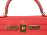 a close up of a red leather handbag on a white background