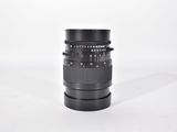 a black camera lens sitting on a white surface