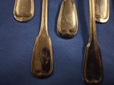 five spoons and two spoons on a blue surface
