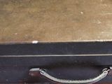 a black suitcase sitting on top of a wooden table