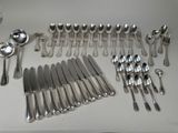 a lot of silver spoons and forks on the table