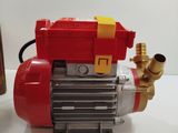 an image of a red and yellow pump on a white table