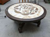 a table with a flower design on it in the middle of a room