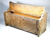 a wooden box with carvings on it on a white surface