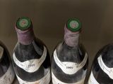 several bottles of wine are lined up in a bucket
