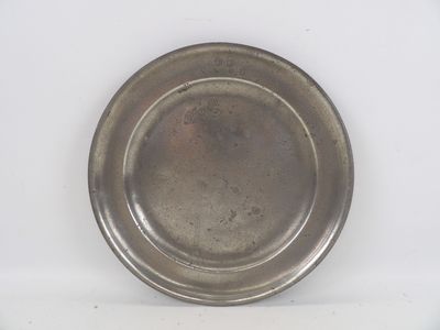 a silver plate on a white surface with a white background