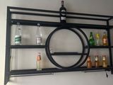 a black shelf with a wine bottle and bottles on it