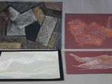 three cards with different designs on them sitting on a table