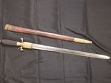 pair of antique japanese swords on a black cloth background
