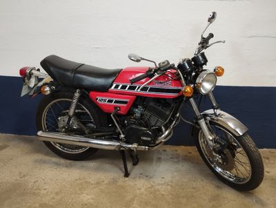 a red and black motorcycle parked in a garage