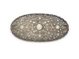 a close up of a pearl and diamond broochle on a white background
