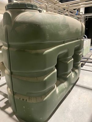a large green tank sitting on top of a table