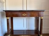 a wooden table with a marble top on a hard wood floor