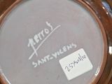 a picture of a brown and white plate with writing on it