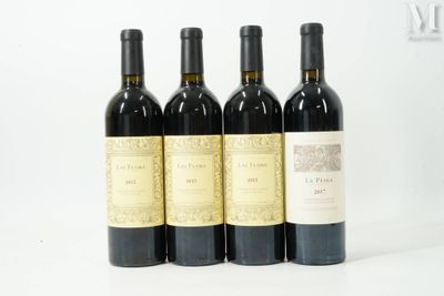 trois bouteilles de vin rouge sont alignées sur une surface blanche