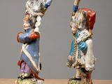 two figurines of a man and a woman on a table