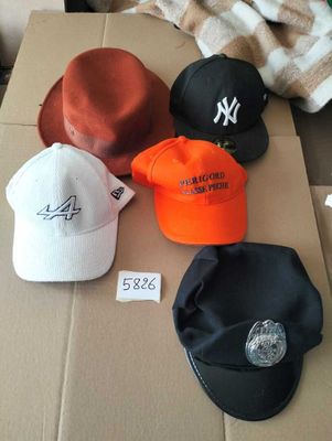 many hats that are sitting on top of a cardboard box