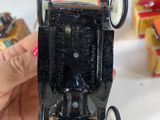 a person holding a small toy car in their hand