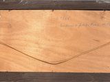 an old picture of a piece of wood with writing on it