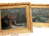 two framed paintings of a house and a barn in a field