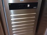 a stainless steel dishwasher in the middle of a kitchen