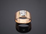 a close up of a gold ring with a diamond on it