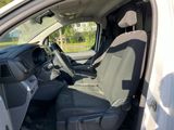 the interior of a car with the door open showing the driver ' s seat