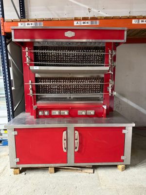 a red oven that is sitting on a pallet