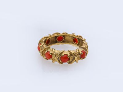 an image of a gold ring with red stones