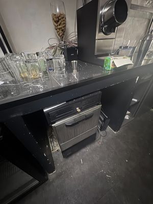 a counter with a bunch of empty glasses on it