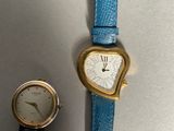 two watches sitting next to each other on a table
