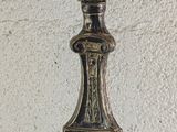 a silver candle that is on a table