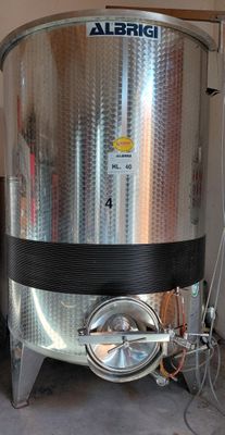 an image of a large stainless steel tank in a garage