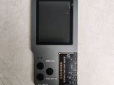 a small black gameboy sitting on top of a table