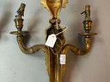 pair of antique brass wall sconces on a white wall