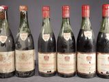six bottles of wine are lined up in a row on a table