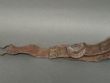 an old brown leather belt with a metal buckle and a butterfly on it