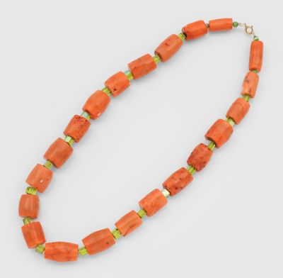 an orange necklace with green beads and a gold clasp