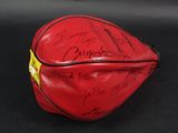 a close up of a red baseball glove with autographs on it