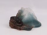 a small piece of blue and brown rock on a white surface