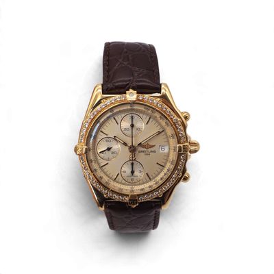 une photo d'une montre dorée et marron sertie de diamants
