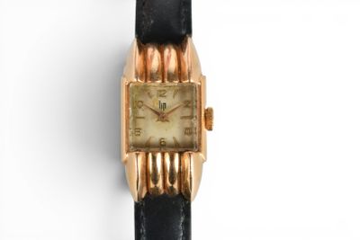 an image of a close up of a wrist watch on a white surface