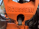 a close up of a large orange machine on the ground