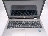 an open laptop computer sitting on top of a white table
